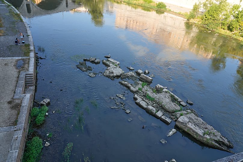 The ruins of the ancient Roman Neronian bridge, emerge from the riverbed of the Tiber river due to drought, in Rome, Thursday, Aug. 13, 2026.