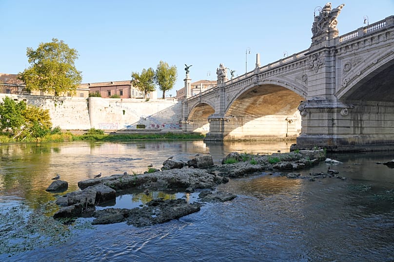 The ruins of the ancient Roman Neronian bridge, emerge from the riverbed of the Tiber river due to drought, in Rome, Thursday, Aug. 13, 2026.