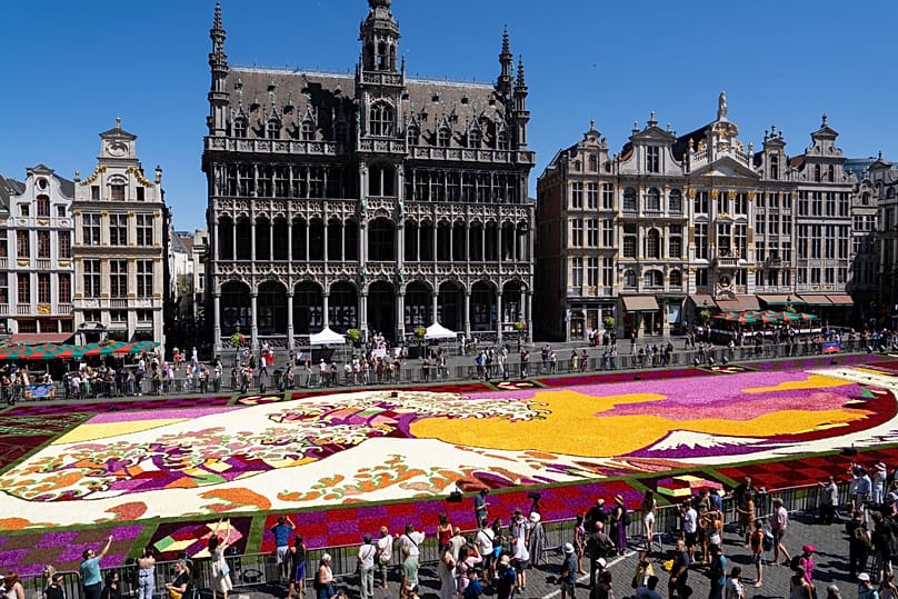 A giant Hokusai-inspired flower carpet at the historic Grand Place in Brussels, Thursday, Aug. 13, 2026. 