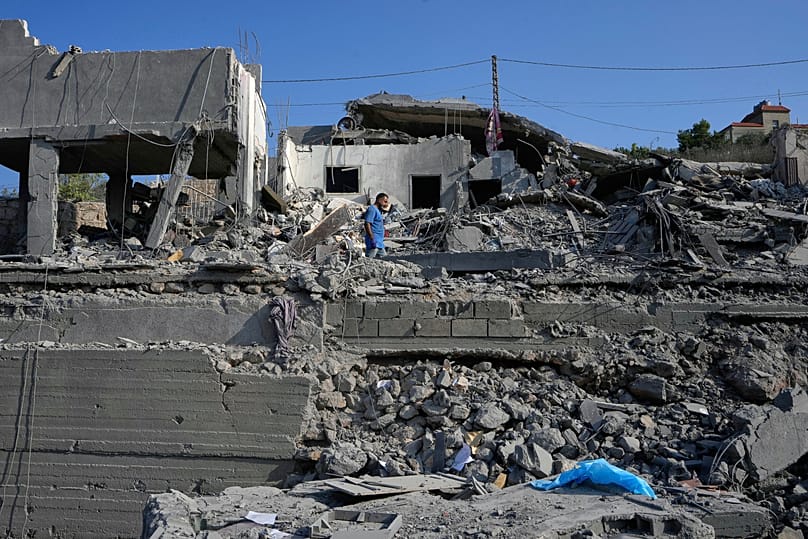 A man checks a destroyed home that was hit by an Israeli airstrike in Ansar village, southern Lebanon, Saturday, Aug. 15, 2026.