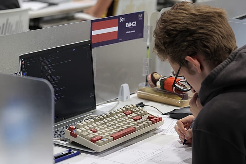 A contestant solves an algorithmic problem at the IOI 