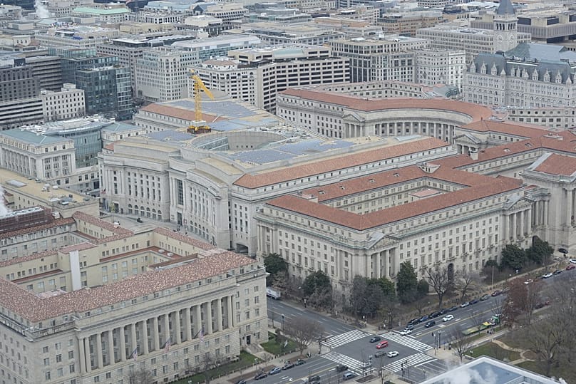 The Ronald Reagan Building, middle, and other office buildings that make up the Federal Triangle complex, are seen from the Washington Monument, Tuesday, 9 Dec, 2025