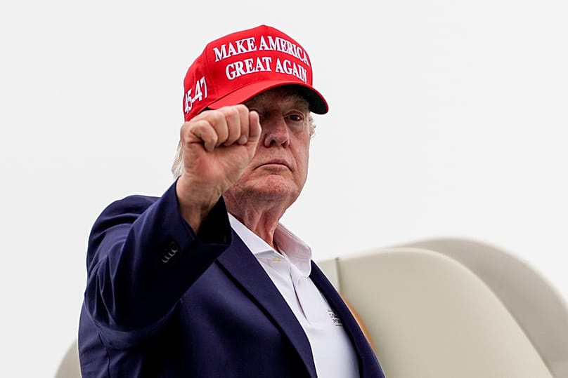 US President Donald Trump gestures while boarding Air Force One at Morristown Airport, Sunday, Aug. 16, 2026, in Morristown, New Jersey