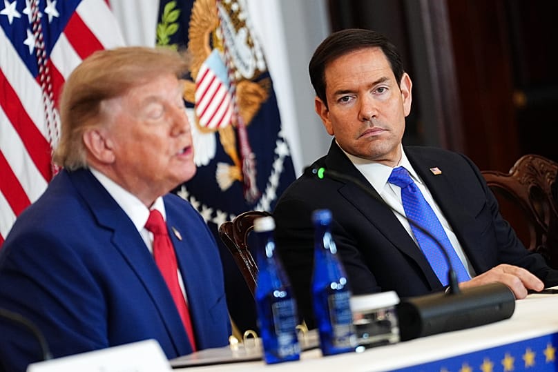 FILE: US Secretary of State Marco Rubio listens as President Donald Trump speaks during a roundtable at the State Department in Washington, 7 August 2026