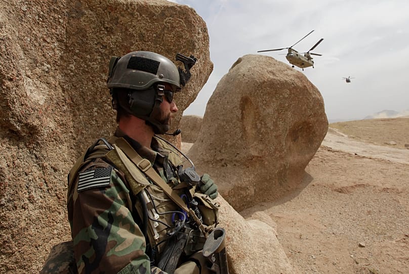FILE: US Special Forces soldier takes cover as two Chinook Ch-47 helicopters come in for a landing with supplies in Afghanistan, 16 September 2009