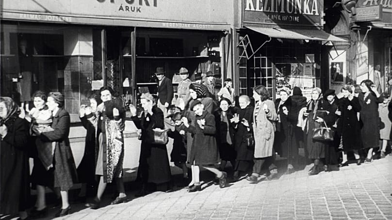Arrow Cross members escort Jews (the Hungarian equivalent of the Nazi Party was the Arrow Cross Party) in front of 32 Rákóczi Road