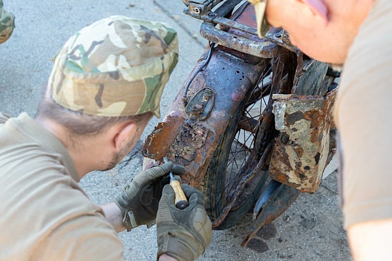The motorcycle undergoing conservation work, partially dismantled, at the site of the HM Military History Institute and Museum on 13 August 2026