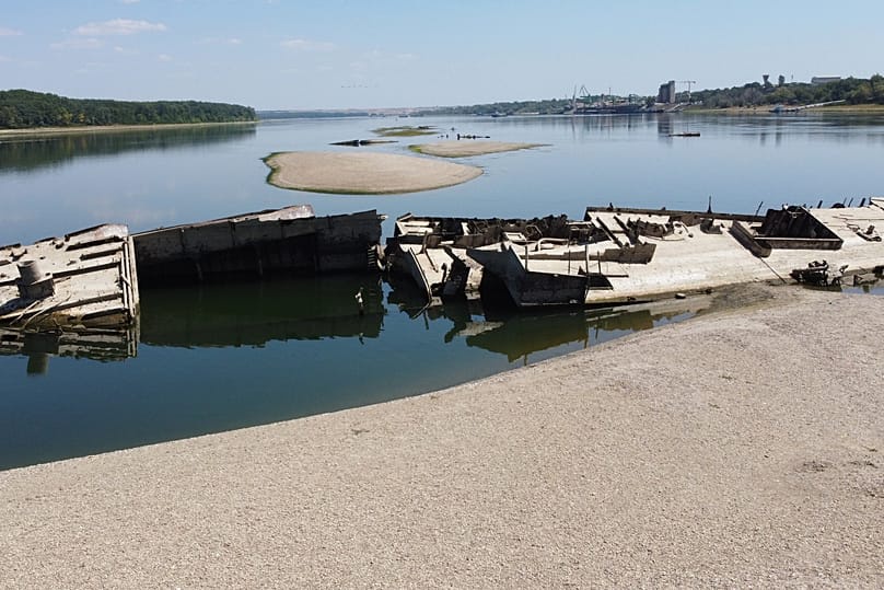 The wreckage of a WWII German warship is seen in front of Djerdap II, a large dam on the Danube River, between Romania and Serbia, near Prahovo, Serbia, Tuesday, Aug. 4, 2026.