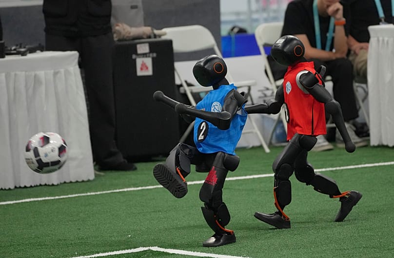 Robots play soccer during the World Humanoid Robot Games in Beijing, Sunday, Aug. 23, 2026.