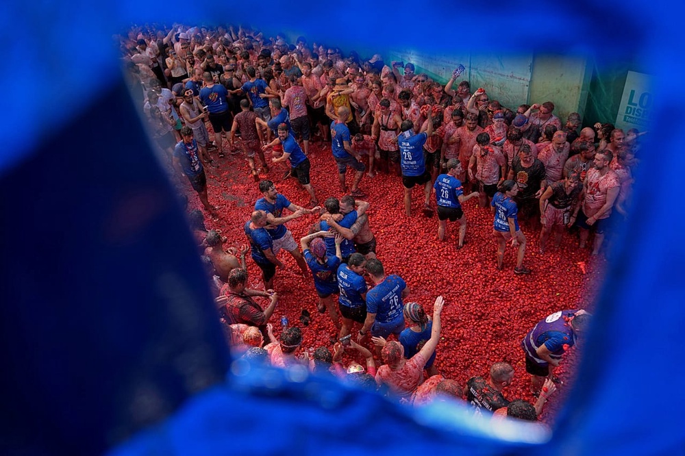 Revelers throw tomatoes at each other during the annual 