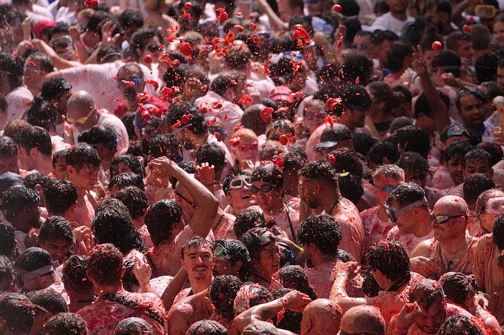 Revelers throw tomatoes at each other during the annual 