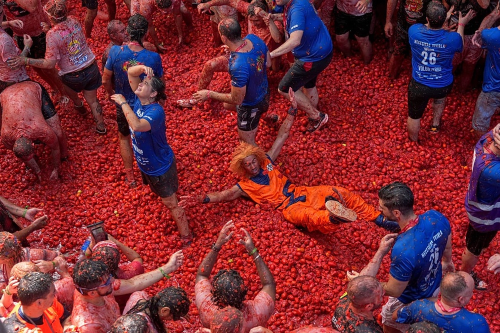 Revelers throw tomatoes at each other during the annual 