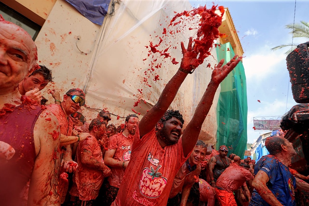 Revelers throw tomatoes at each other during the annual 