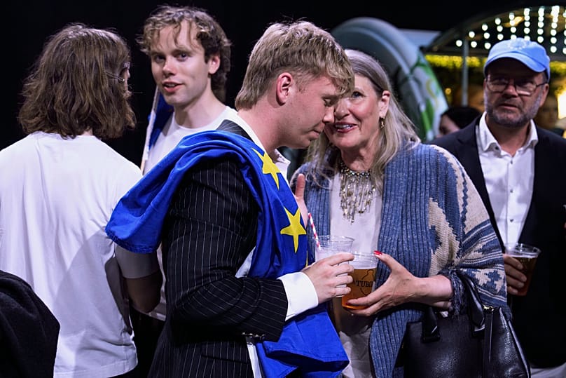 A supporter wearing a European Union flag attends an election-night gathering in Reykjavik, Iceland, Sunday, Aug. 30, 2026.