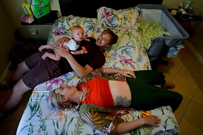 Russian nationals Alla Priglovkina and Andrei Ushakov spend time with their son Lev Andres, who was born in Argentina, in the bedroom of their home in Mendoza, Argentina, 14.02.2023.