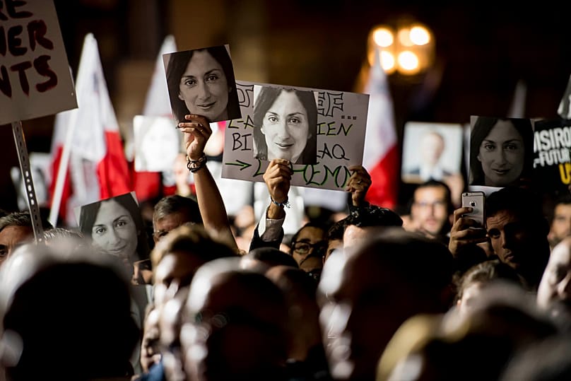 Protesters hold photos during a protest outside the office of the Prime Minster of Malta by civil groups Occupy Justice and Republica, 29 November, 2019