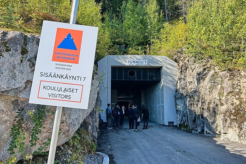 People stand at an entrance of a shelter designed to withstand chemical, nuclear and biological attacks in Kuopio, 2 September, 2026