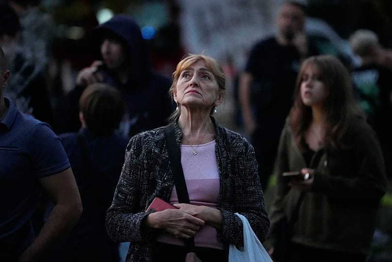 People look at a damaged residential building following a Russian drone strike in Kyiv, 3 September, 2026