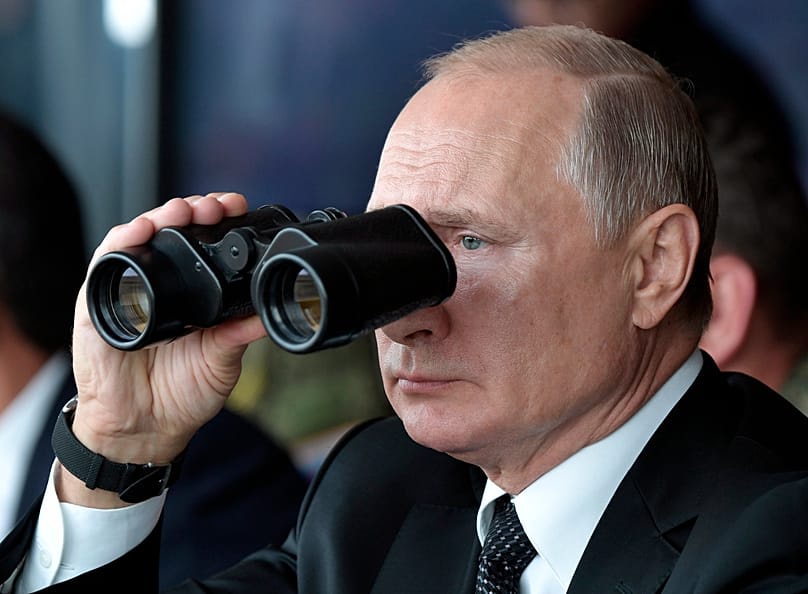 Russian President Vladimir Putin holds binoculars while watching military exercises in Orenburg, Russia, 20 September 2019. 