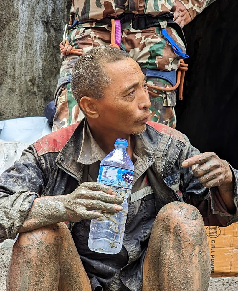  Chinese national is seen drinking water after being rescued by soldiers during an ongoing operation at the Trishuli-3A hydropower project in Nepal's Rasuwa district, 05.09.26