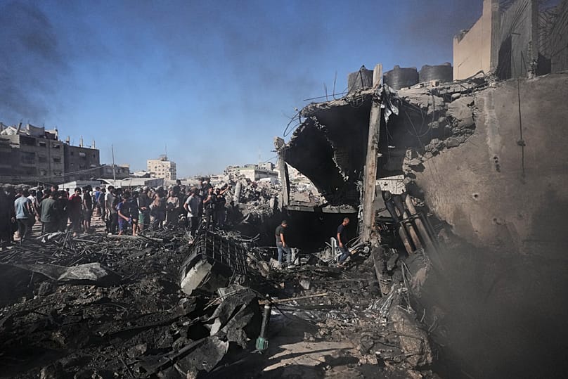 Palestinians gather and inspect the rubble of a building destroyed in an Israeli airstrike in Gaza City, 24 August, 2026