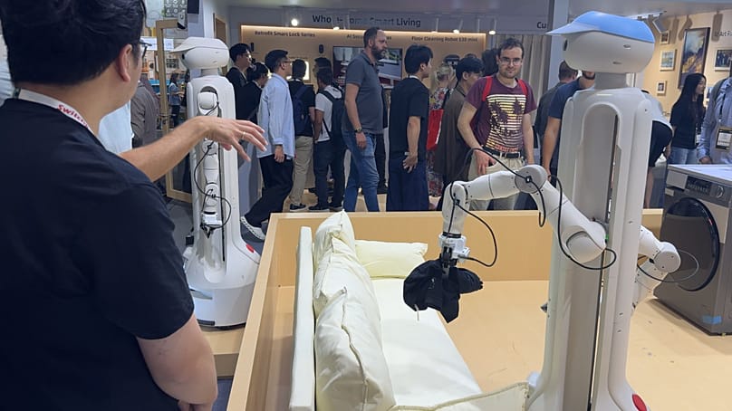 US-based SwitchBot demonstrated a robot loading clothes into a washing machine.