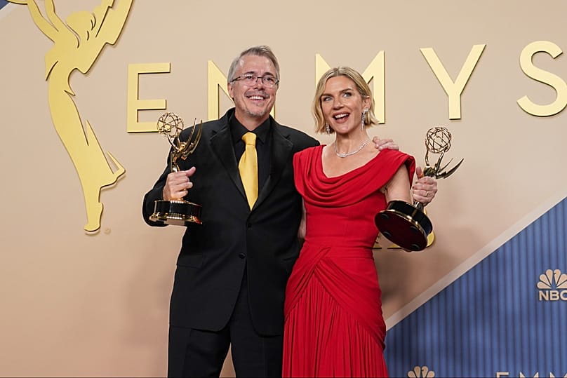 Vince Gilligan, left, poses in the press room with the award for outstanding writing for a drama series for Pluribus with Rhea Seehorn with the outstanding lead actress award 