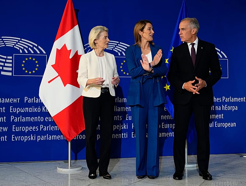Mark Carney participates in a welcoming ceremony with President of the European Parliament Roberta Metsola, center, and President of European Commission Ursula von der Leyen.