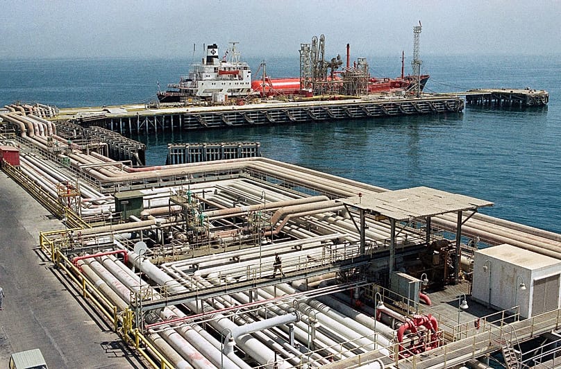 Oil pipelines snake through the port area of the Aramco facility at Ras Tannura, Saudi Arabia, Sept. 25, 1990, as a Panamanian ship sits tied to the dock.