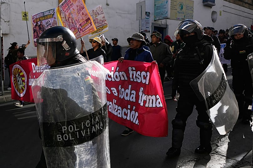 Police escort teachers during an anti-government protest in La Paz, Bolivia, Tuesday, Sept. 15, 2026