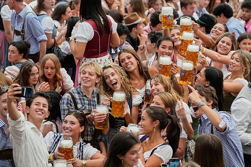 People celebrate after the opening of the 191st Oktoberfest in Munich on Saturday, 19 September 2026.
