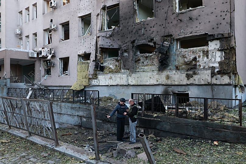 Police officers stand in front of a hospital damaged in a Russian drone strike in Zaporizhzhia, 25 September, 2026