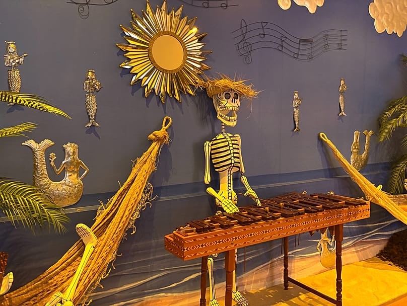 Image of part of Casa de México's 2026 Day of the Dead exhibition with 'skeleton' mermaids made from embossed tin.