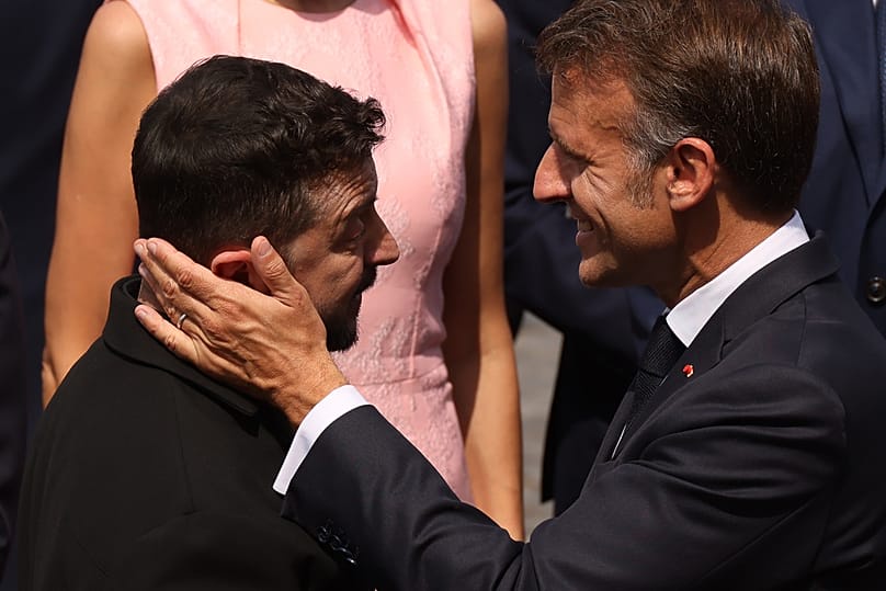 French President Emmanuel Macron, right, speaks with Ukraine's President Volodymyr Zelenskyy after the Bastille Day military parade on the Champs-Elysées avenue, 14 July 2026