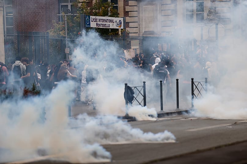 Riot police throw tear gas as high school students block the entrance of a school in Lille, 30 September, 2026