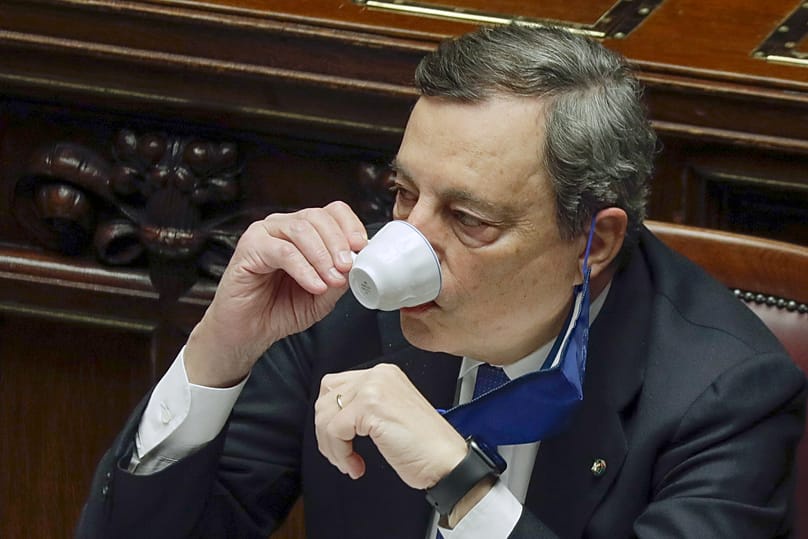 Former Italian prime minister and ECB president Mario Draghi sips an espresso during a break in proceedings in the Chamber of Deputies (18 February 2021)