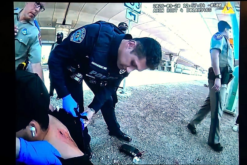 Officers inspect Wilber Rafael Garces Perez's wound after he was shot by a US Immigration and Customs Enforcement agent Sunday, Sept. 20 in Austin