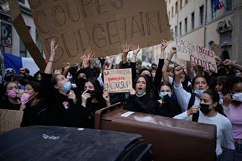 Students hold a sign reading 