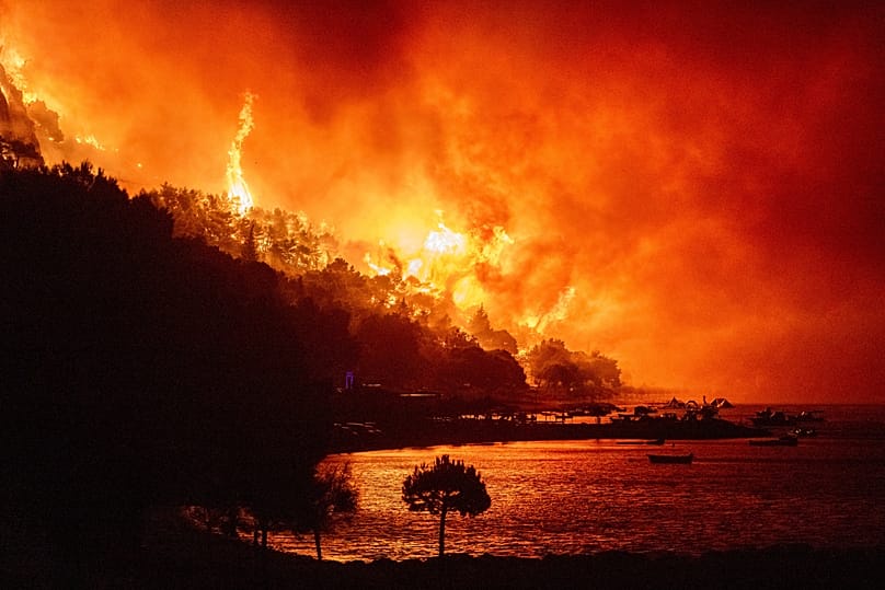 A wildfire approaches a beach on the Adriatic coast near Omis, 14 August, 2026
