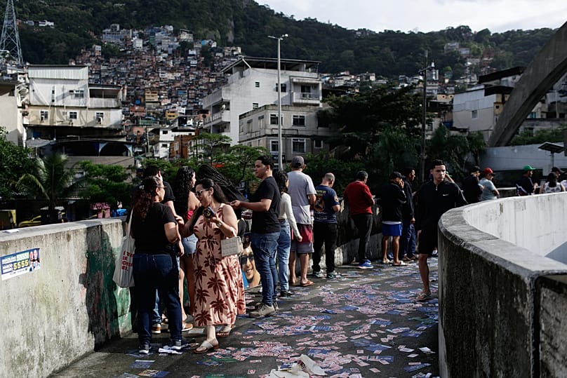 Voters queue at a polling station during the general election in Rio de Janeiro on Sunday, 4 October 2026.