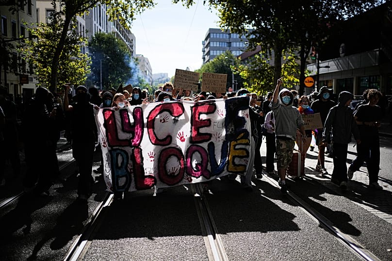 Pupils hold up a banner reading 