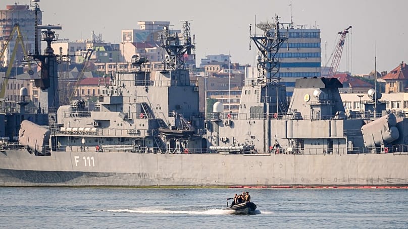 A boat sails past the Romanian frigate Marasesti docked in Constanta, Bulgaria, following the explosion of a maritime drone in the Black Sea, 5 June, 2026. 