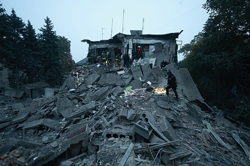 Rescue workers clear the rubble of a residential building destroyed by a Russian airstrike in Zaporizhzhia, Ukraine, Saturday, Oct. 10, 2026.