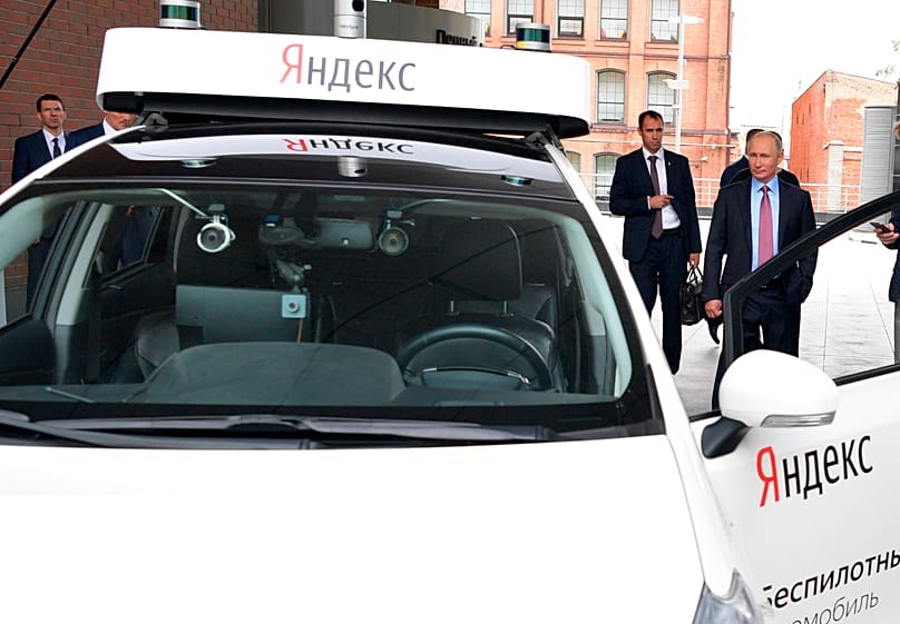 Putin inspects a working prototype of an autonomous vehicle during a visit to the headquarters of Russia's largest search engine 