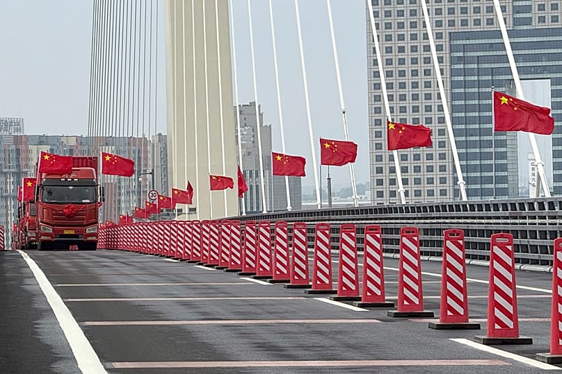 Chinese flags are flown during the opening ceremony of the new China-North Korea Yalu River Bridge, 15 October, 2026