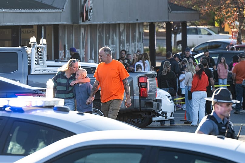 People leave a family meeting area following a shooting at Silver Rail Elementary School, 15 October, 2026