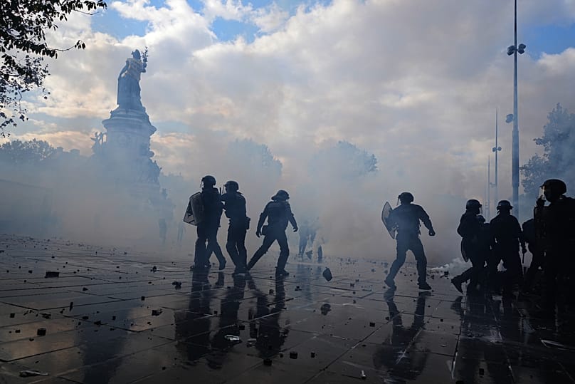 Police scuffle with protesters during a demonstration against rising living costs, joining students' grievances, in Paris, Saturday, Oct. 17, 2026.