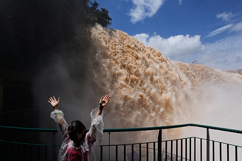 A tourist stands on a walkway overlooking Iguazu Falls in Foz do Iguacu, Brazil, Friday, Oct. 16, 2026. 