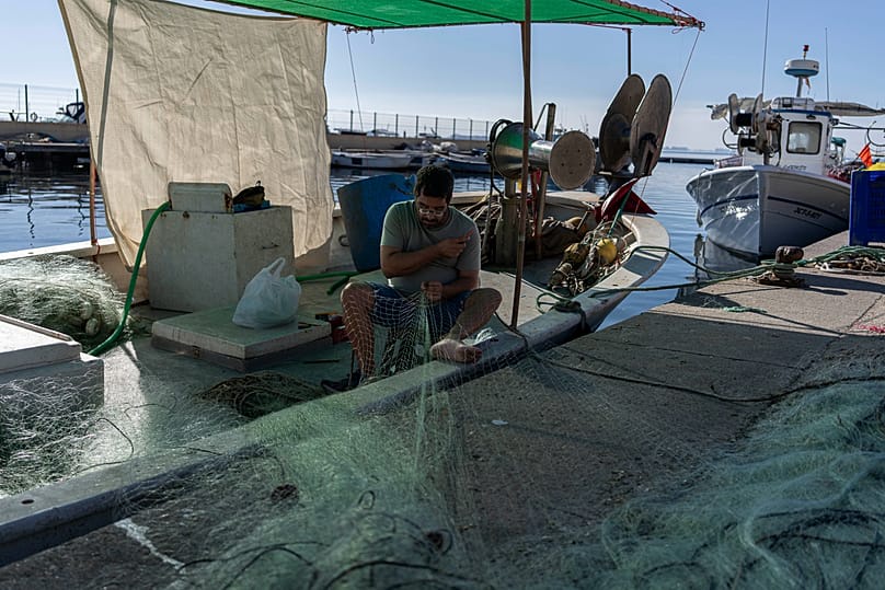 Rubén Albaladejo on his fishing boat, moored at the fishermen's guild in San Pedro del Pinatar, Murcia.