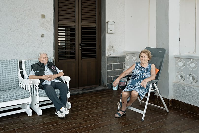 Fina and her husband pose at the door of their beachfront home in Los Urrutias, on the Mar Menor in Murcia.